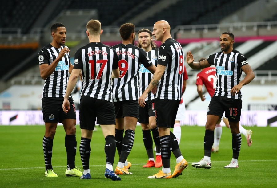 FILE PHOTO: Soccer Football - Premier League - Newcastle United v Manchester United - St James' Park, Newcastle, Britain - October 17, 2020 Newcastle United players celebrate after Manchester United's Luke Shaw scored an own goal and the first for Newcastle Pool via REUTERS/Alex Pantling/File photo